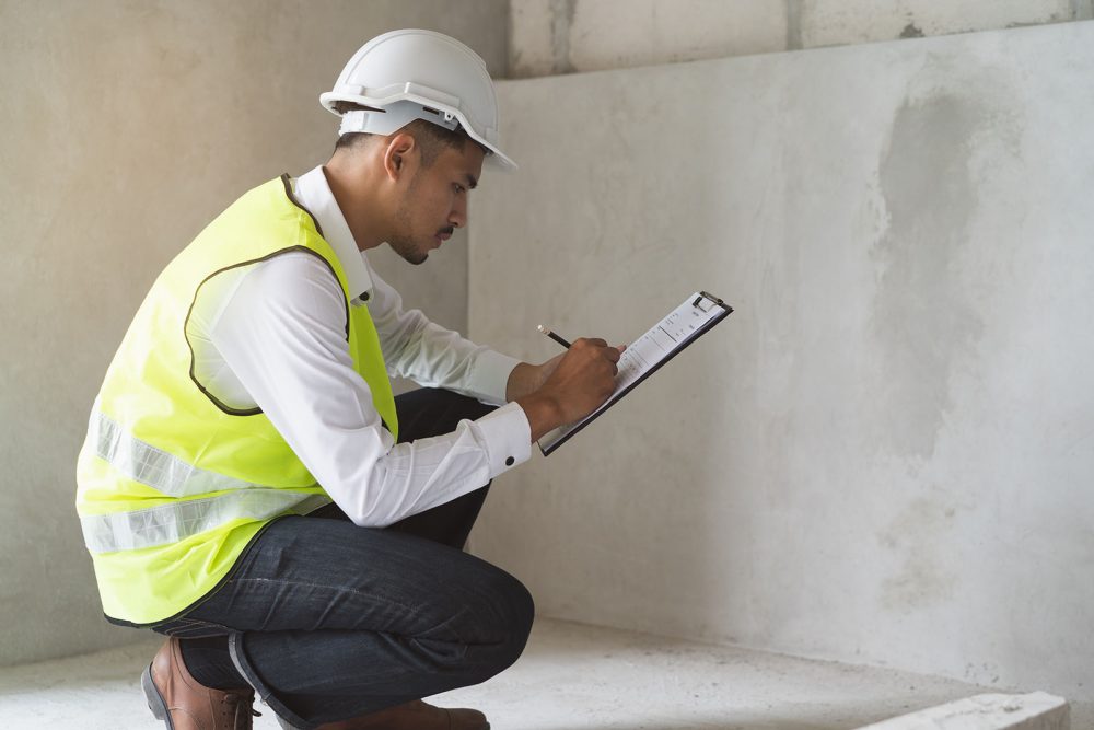 A building inspector reviews construction and materials for safety.